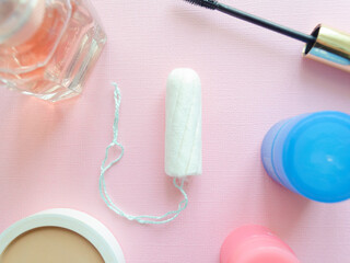 Female tampon on a pink background. Hygienic white tampon for women. Cotton swab. Menstruation, protection concept. Flat Lay