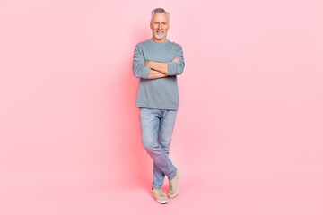 Photo of charming sweet man pensioner dressed grey shirt smiling arms crossed isolated pink color...