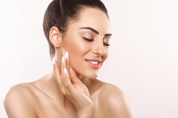 Beauty and Spa Concept. Beautiful Young Woman with Clean Fresh Skin touch face. Facial treatment....