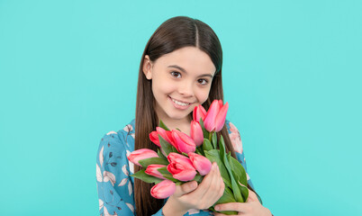 teen girl with spring bouquet on blue background. floral present. happy child enjoy tulips.