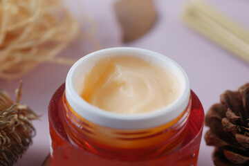 herbal cream cosmetic in a container on table,