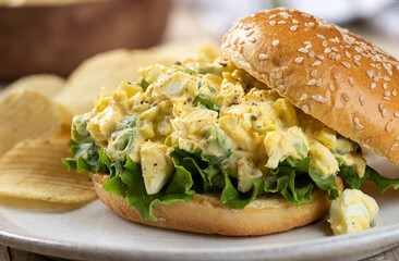 Egg salad sandwich with lettuce on sesame seed bun