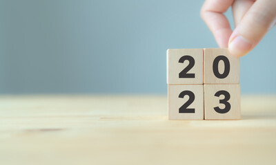 2023 Happy new year.  Starting to new year.  2023 written on wooden cubes with smart background....