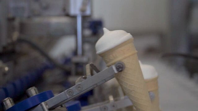 Ice Cream Production Factory. ice cream production, transportation waffle-cone with plombir ice cream on conveyor, production line, dairy products.