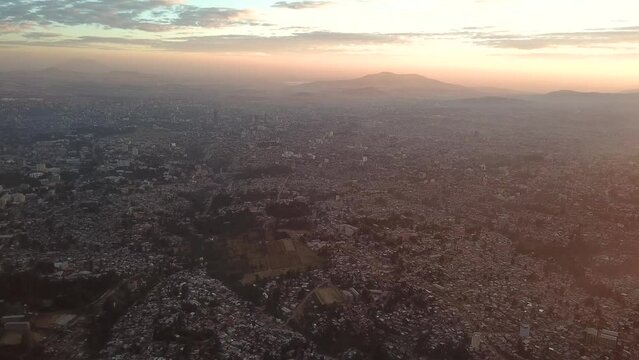 High rise aerial above huge metropolitan area in Africa during sunset. Addis Ababa, Ethiopia