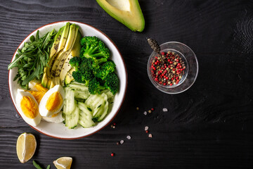 Obraz na płótnie Canvas Diet menu. Healthy lifestyle bowl with avocado, cucumber, broccoli and egg. Healthy organic vegan salad. Delicious breakfast or snack, Clean eating, dieting, vegan food concept. top view