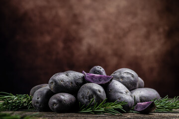 Raw sweet potatoes on wooden background, Organic purple sweet potato. Raw sweet potatoes or batatas. pomoea batatas. Batata potato, banner, menu, recipe place for text, top view
