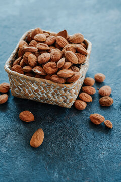 shelled almonds in a square palm-woven basket