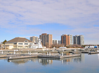 View past the the Bronte Outer Harbour Marina on lake Ontario, towards the skyline of Oakville, ON, Canada