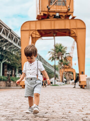 Toddler strolling at Estação das Docas, in Belém, Pará, Amazon, Brazil. - obrazy, fototapety, plakaty