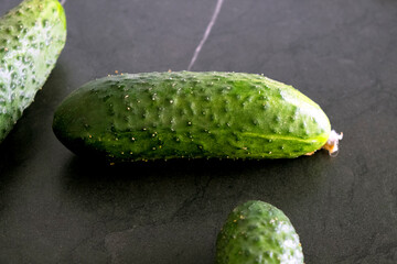 Big cucumber on black background
