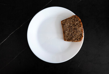 White bread on black background, top view