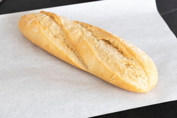 freshly baked bread on white parchment, side view. Bread on the table
