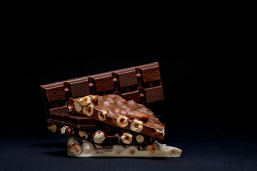 Top view in section on a bar of dark chocolate with hazelnuts