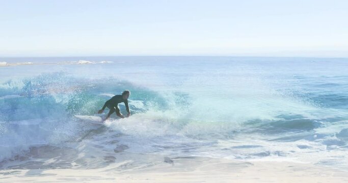 Animation of landscape with ocean over caucasian male surfer surfing