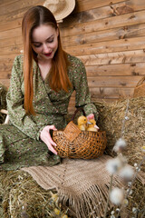 A young woman holding basket with cute little ducks.Easter or farming concept.Pets