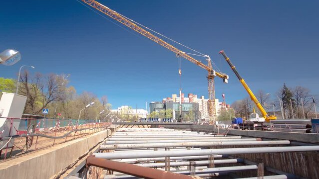A large huge ditch pit tunnel timelapse hyperlapse. Reinforcing structures from thick iron pipes of beams and structures at the construction site of the underground metro station line.