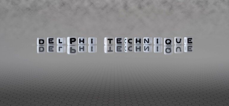delphi technique word or concept represented by black and white letter cubes on a grey horizon background stretching to infinity