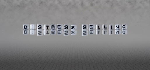 distress selling word or concept represented by black and white letter cubes on a grey horizon...