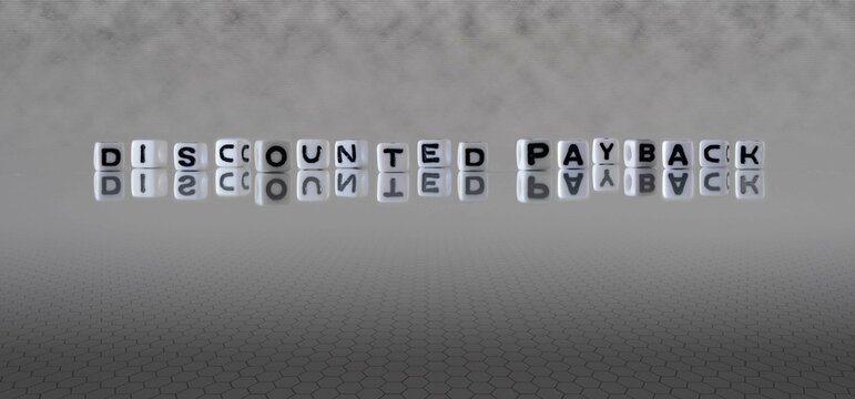 discounted payback word or concept represented by black and white letter cubes on a grey horizon background stretching to infinity