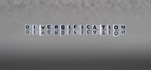 diversification word or concept represented by black and white letter cubes on a grey horizon background stretching to infinity