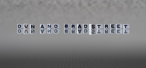 dun and bradstreet word or concept represented by black and white letter cubes on a grey horizon...