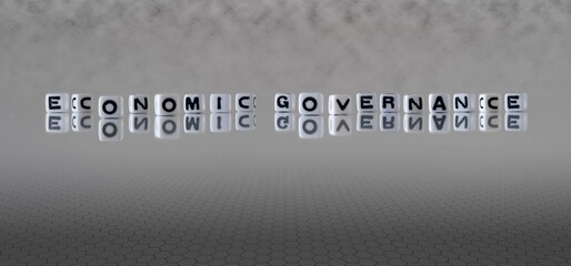 economic governance word or concept represented by black and white letter cubes on a grey horizon...