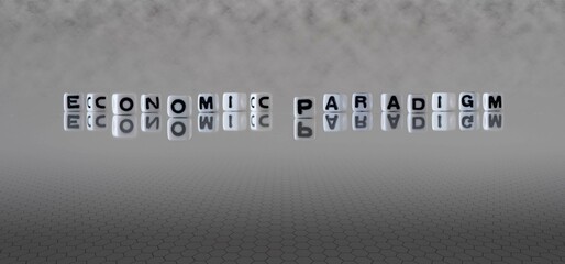 economic paradigm word or concept represented by black and white letter cubes on a grey horizon background stretching to infinity - obrazy, fototapety, plakaty