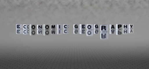 economic geography word or concept represented by black and white letter cubes on a grey horizon background stretching to infinity