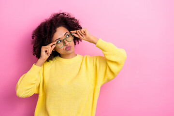 Photo of uncertain shiny lady wear yellow sweater spectacles looking empty space isolated pink color background