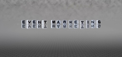 event marketing word or concept represented by black and white letter cubes on a grey horizon background stretching to infinity