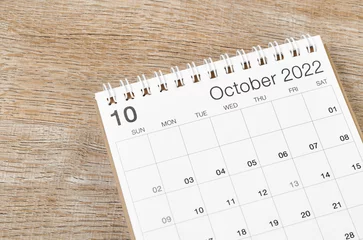 Fotobehang October 2022 desk calendar on wooden background. © gamjai
