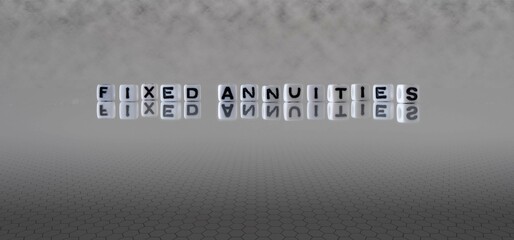 fixed annuities word or concept represented by black and white letter cubes on a grey horizon background stretching to infinity - obrazy, fototapety, plakaty