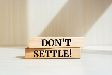 Wooden blocks with words 'Don't settle'.