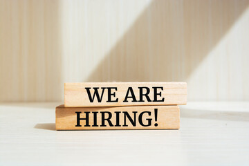 Wooden blocks with words 'We Are Hiring'. Business concept