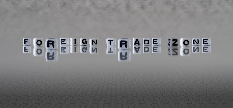 foreign trade zone word or concept represented by black and white letter cubes on a grey horizon background stretching to infinity