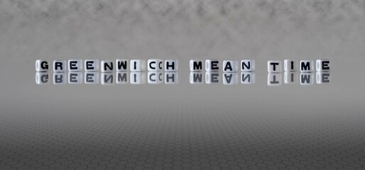 greenwich mean time word or concept represented by black and white letter cubes on a grey horizon...