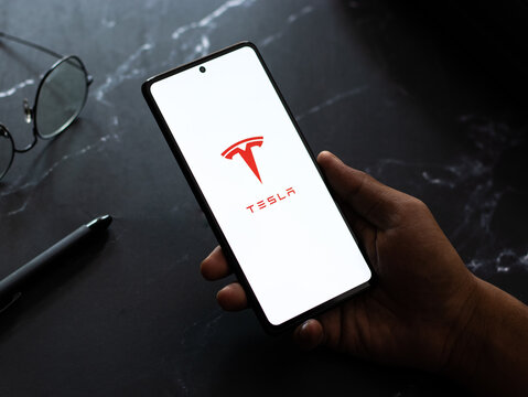 West Bangal, India - April 20, 2022 : Tesla on phone screen stock image.