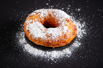 Sugar donut on a black background