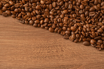 Coffee beans with space for text on wooden table