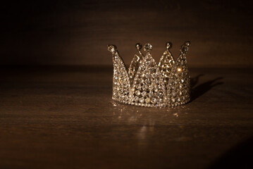 Little crown, vintage. On wooden background. King, queen, prince and princess © Elina Leonova