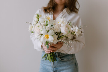 Beautiful bouquet of flowers in female hands. Spring plants.
