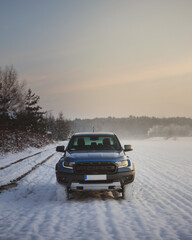 Ford Ranger raptor in the snow at sunset