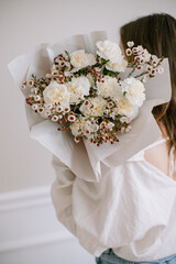 Beautiful bouquet of flowers in female hands