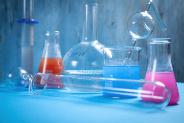 Science glassware with colored liquid in chemistry laboratory.