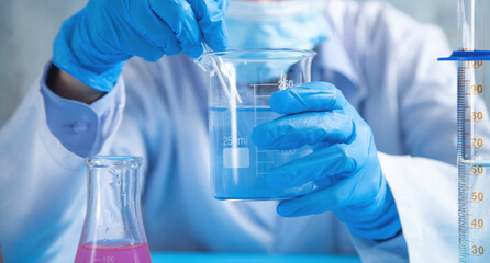Fototapeta premium Girl working with flask in a laboratory.