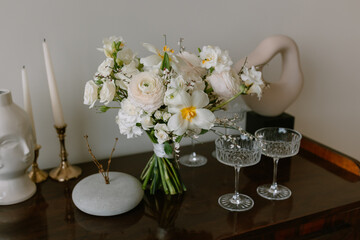 Bouquet of flowers on a pedestal with martini glasses