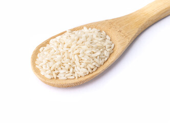 Raw carnaroli risotto rice on a spoon isolated over white background