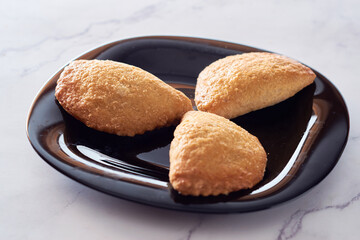 latin american baked sweet empanadas with dulce de leche