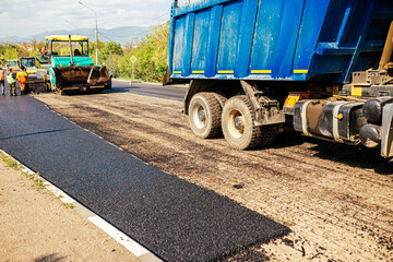 Laying a new asphalt on the road. Construction of the road